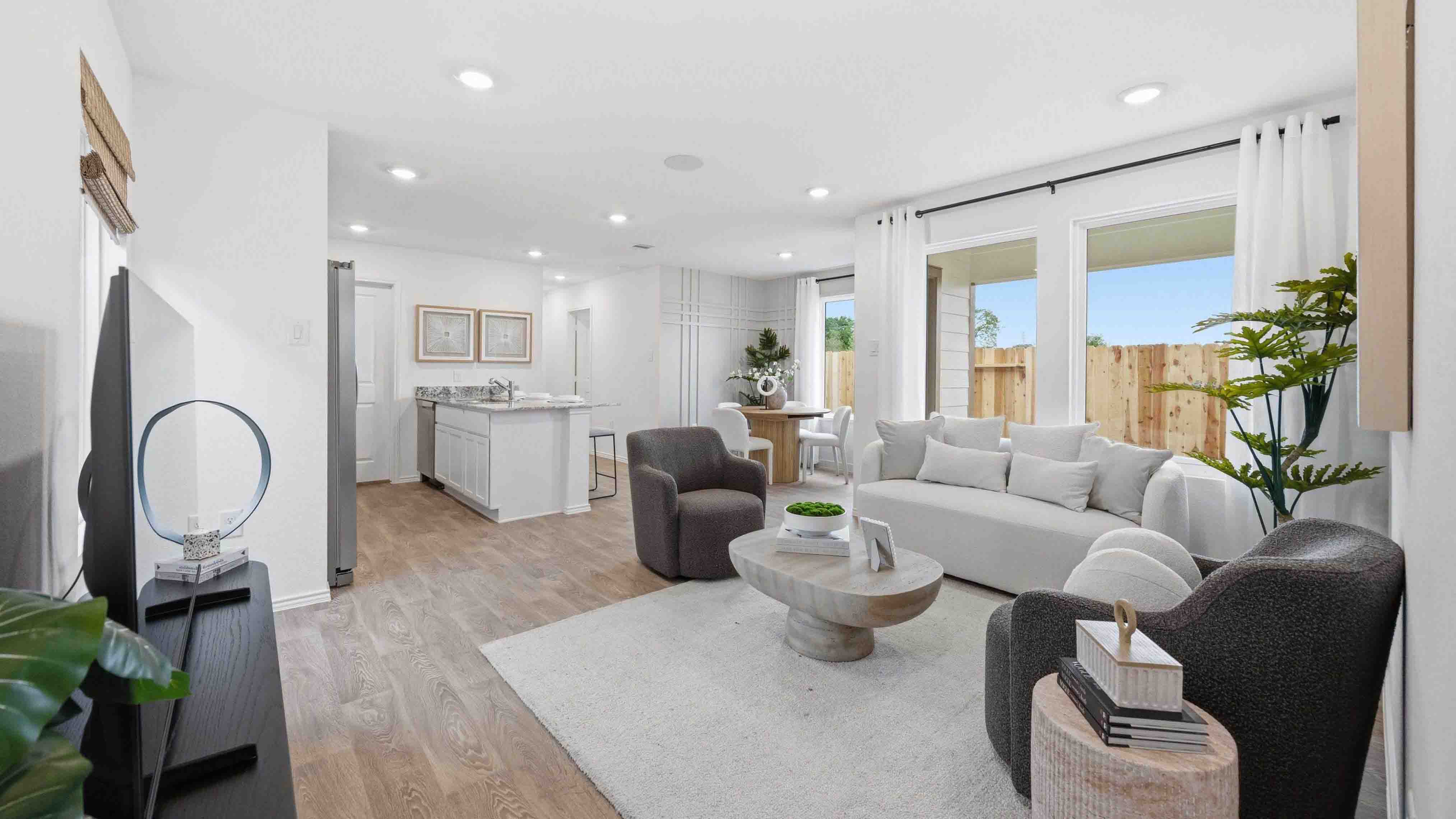 living room area with two large windows towards the side of the home