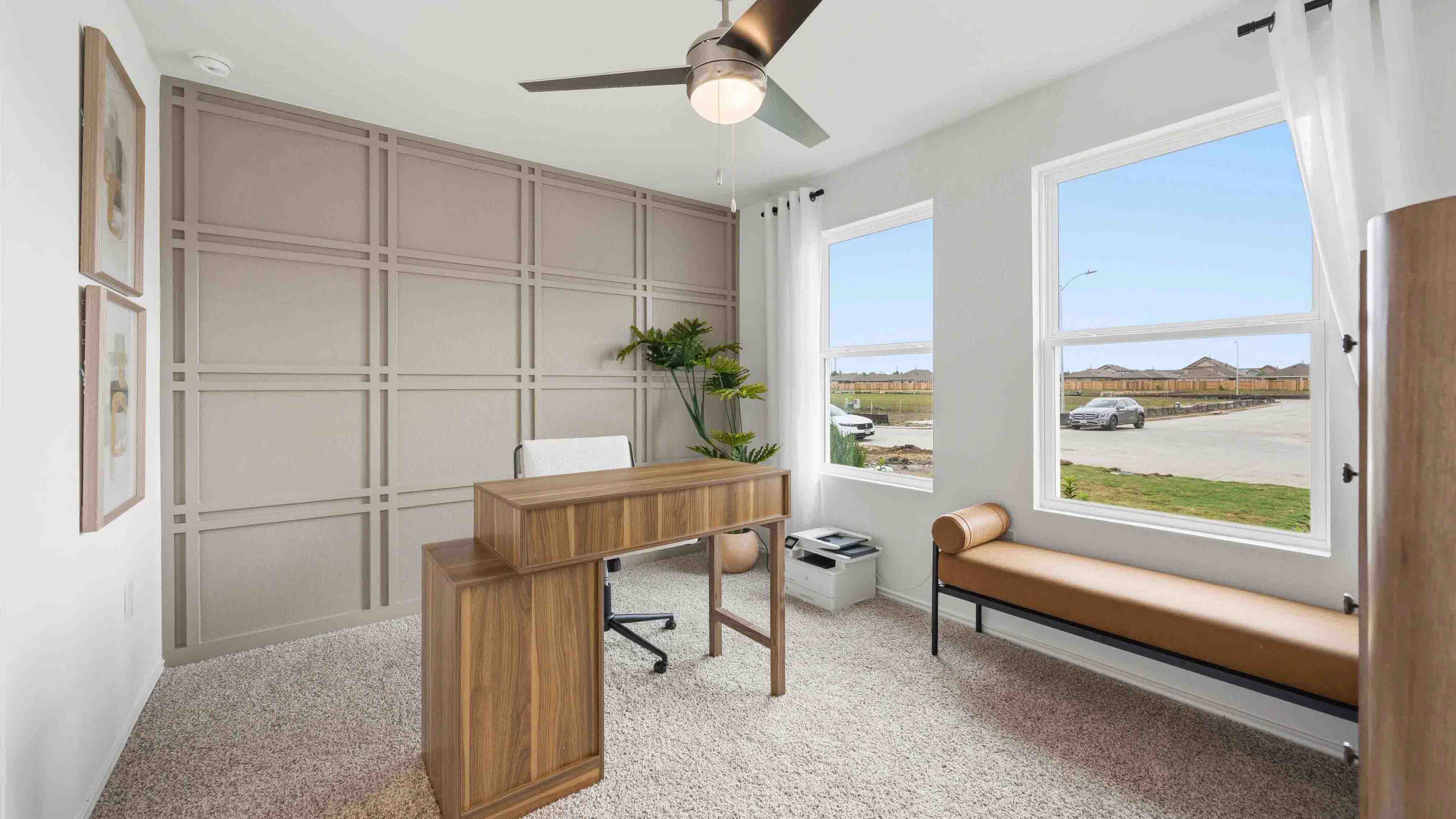 primary bedroom at the front of the home with two large windows