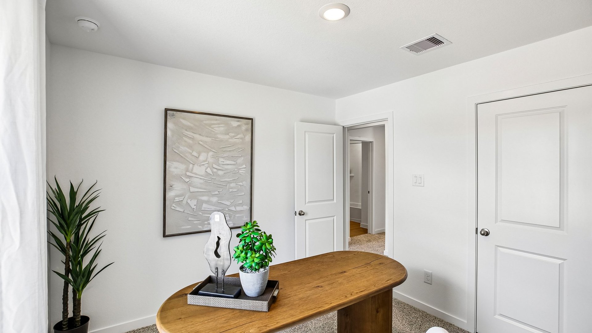 Flexible secondary room staged as a home office with space for productivity and remote work.