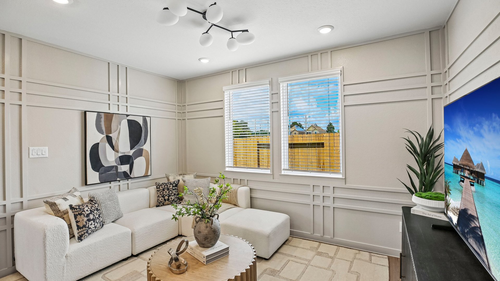 Open living room filled with natural light and contemporary finishes designed for everyday comfort.