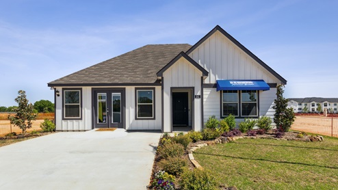 Single story home with white siding and a blue D.R. Horton awning