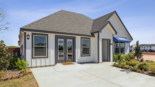 Single story home with white siding and a blue D.R. Horton awning