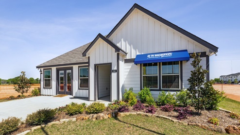 Single story home with white siding and a blue D.R. Horton awning