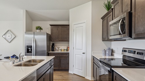 Kitchen island with brown cabinets and stainless steel appliances