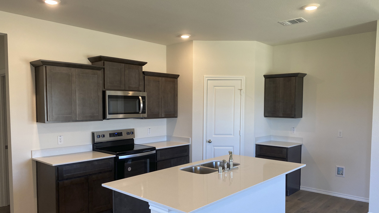 kitchen area with hardwood floors and dark cabinets