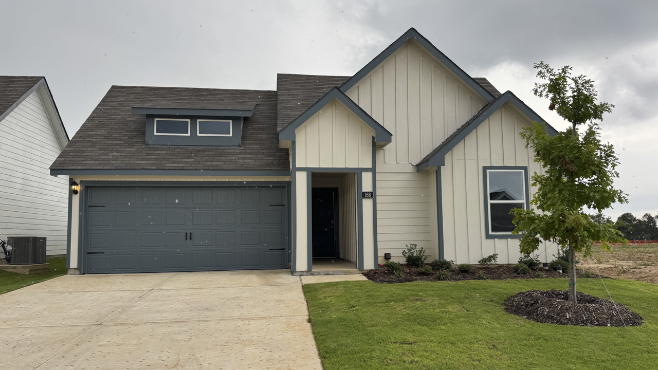 one story home with siding exterior and front middle entrance