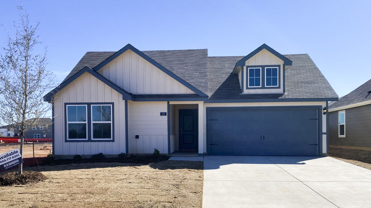 exterior of one story home with white siding and blue accents