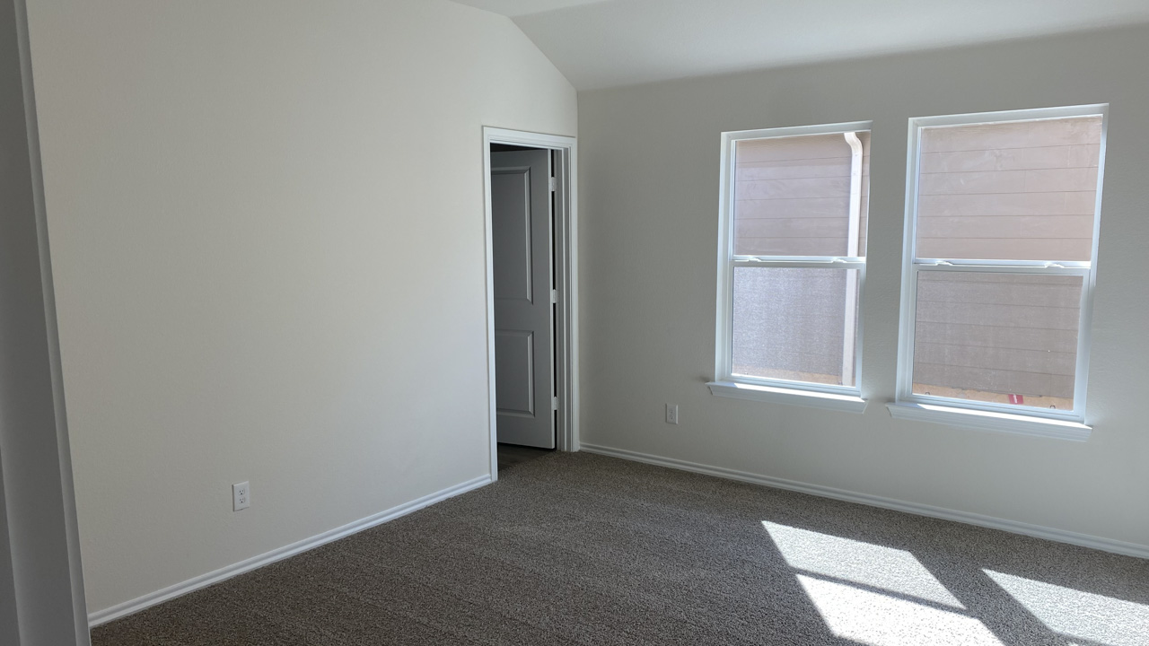 primary bedroom with large windows and natural light