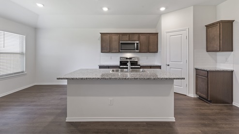 X40A kitchen with white countertops and wood cabinets