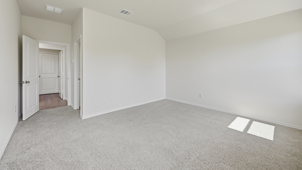 primary bedroom with light grey carpet
