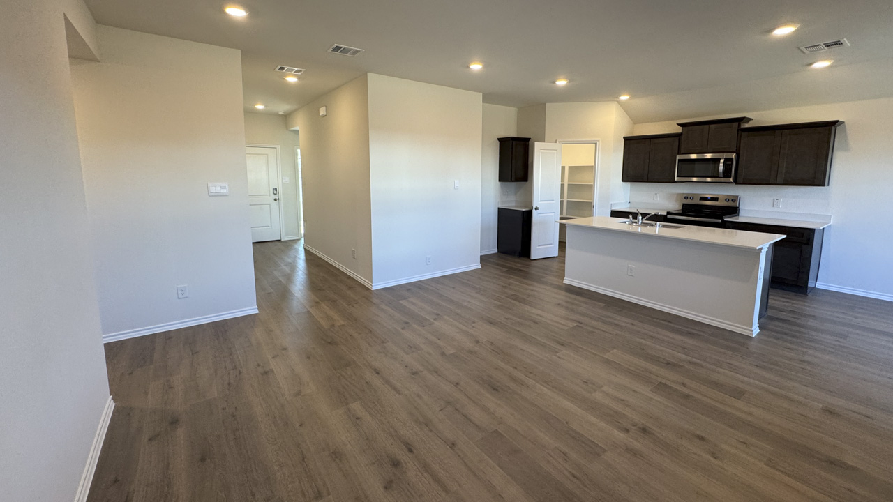 Open concept living area with hardwood floors