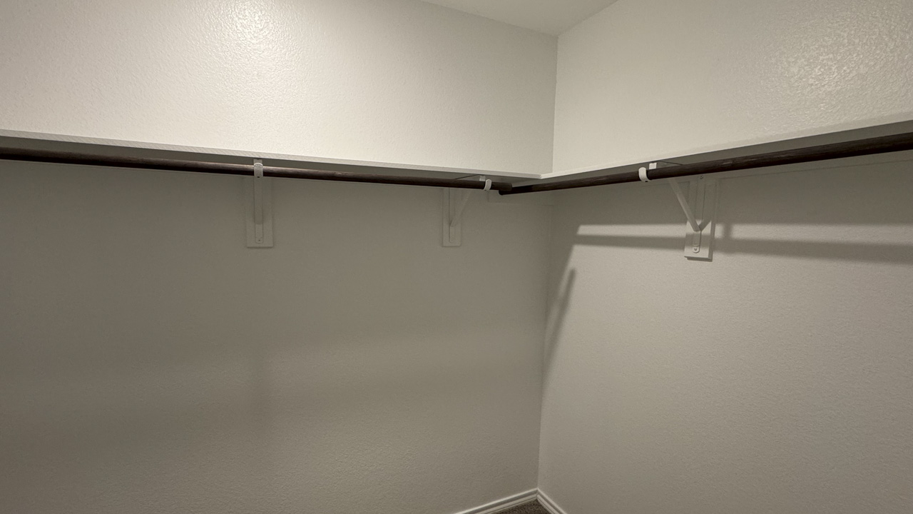 Primary bedroom walk in closet