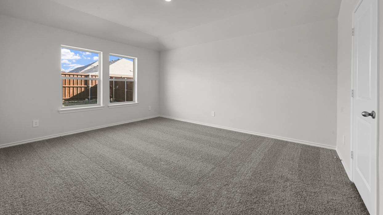 primary bedroom with grey carpet