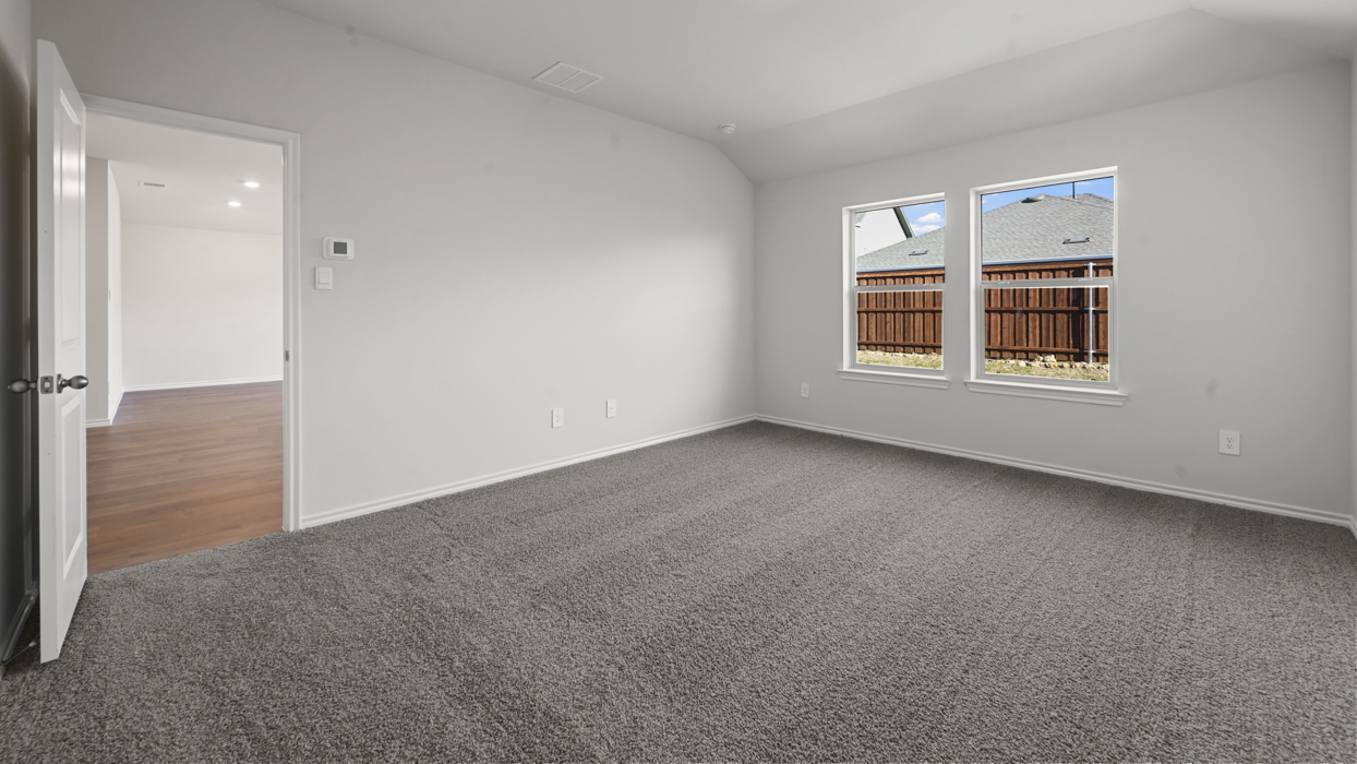 primary bedroom with grey carpet