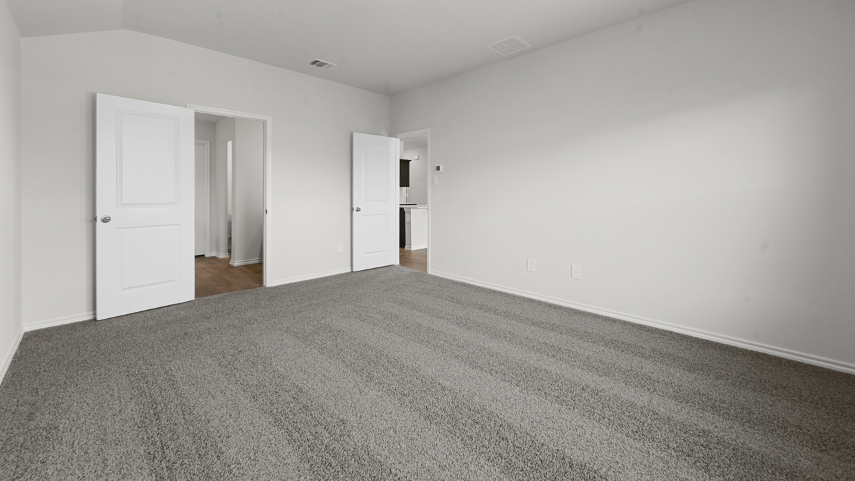 primary bedroom with grey carpet
