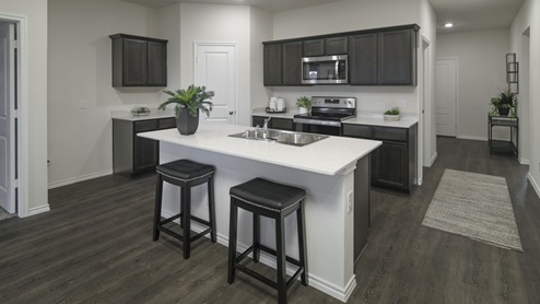 X40D kitchen area with white countertops and dark cabinets