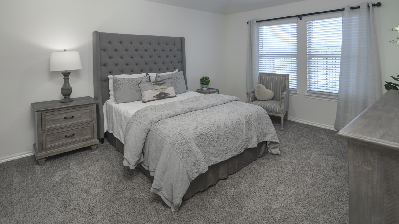 X40I primary bedroom with carpet and natural lighting