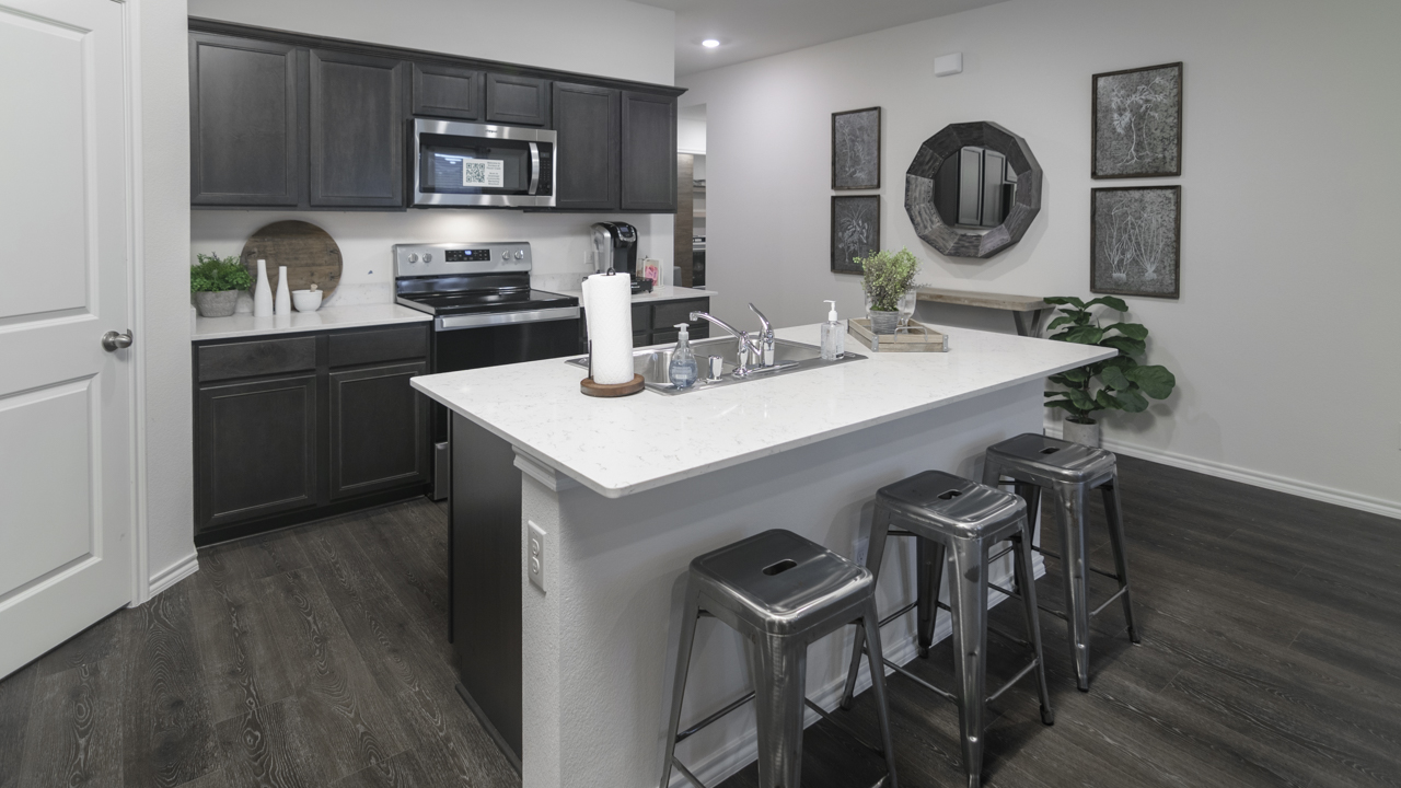 X40I kitchen area with white counters and dark cabinets