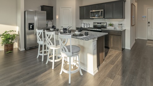 X40M kitchen area with granite countertops and dark cabinets