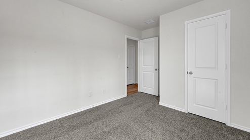 X40A secondary bedroom with carpet
