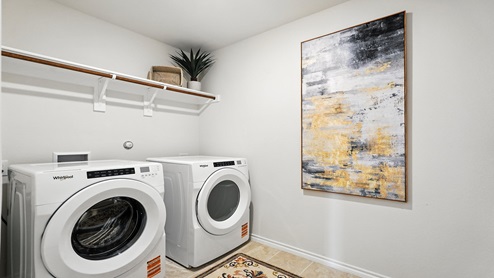 Laundry room with built in shelving.
