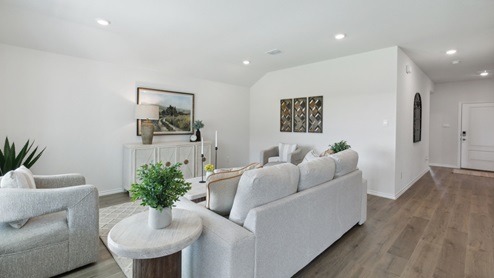 Huntsville model living room with furniture and windows overlooking kitchen