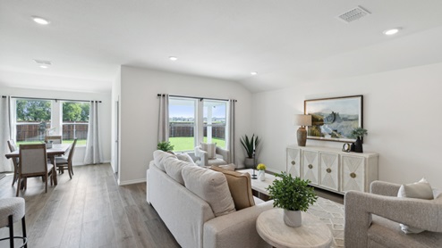 Huntsville model living room with furniture and windows overlooking kitchen