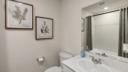 Secondary bathroom with vanity and commode