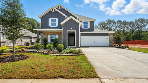 Front exterior of home with partial brick siding.