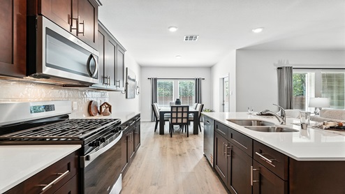 Kitchen with an island and quartz countertops.