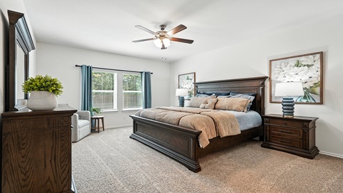 Bedroom with carpeted floors and a large window.