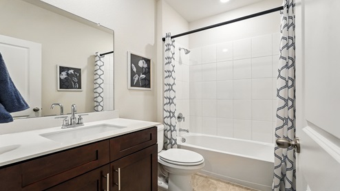 Bathroom with a single vanity sink and a step in shower.