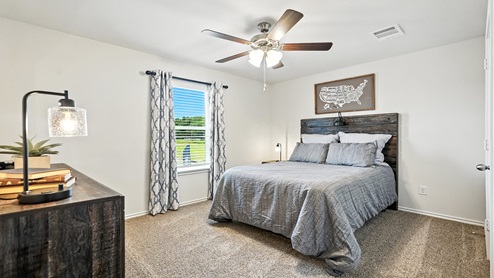 Bedroom with carpeted floors and a window.