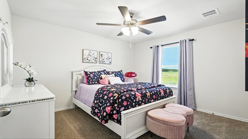 Bedroom with carpeted floors and a window.