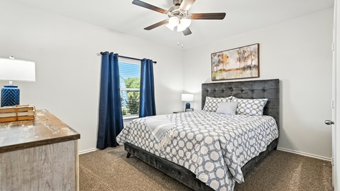 Bedroom with carpeted floors and a window.