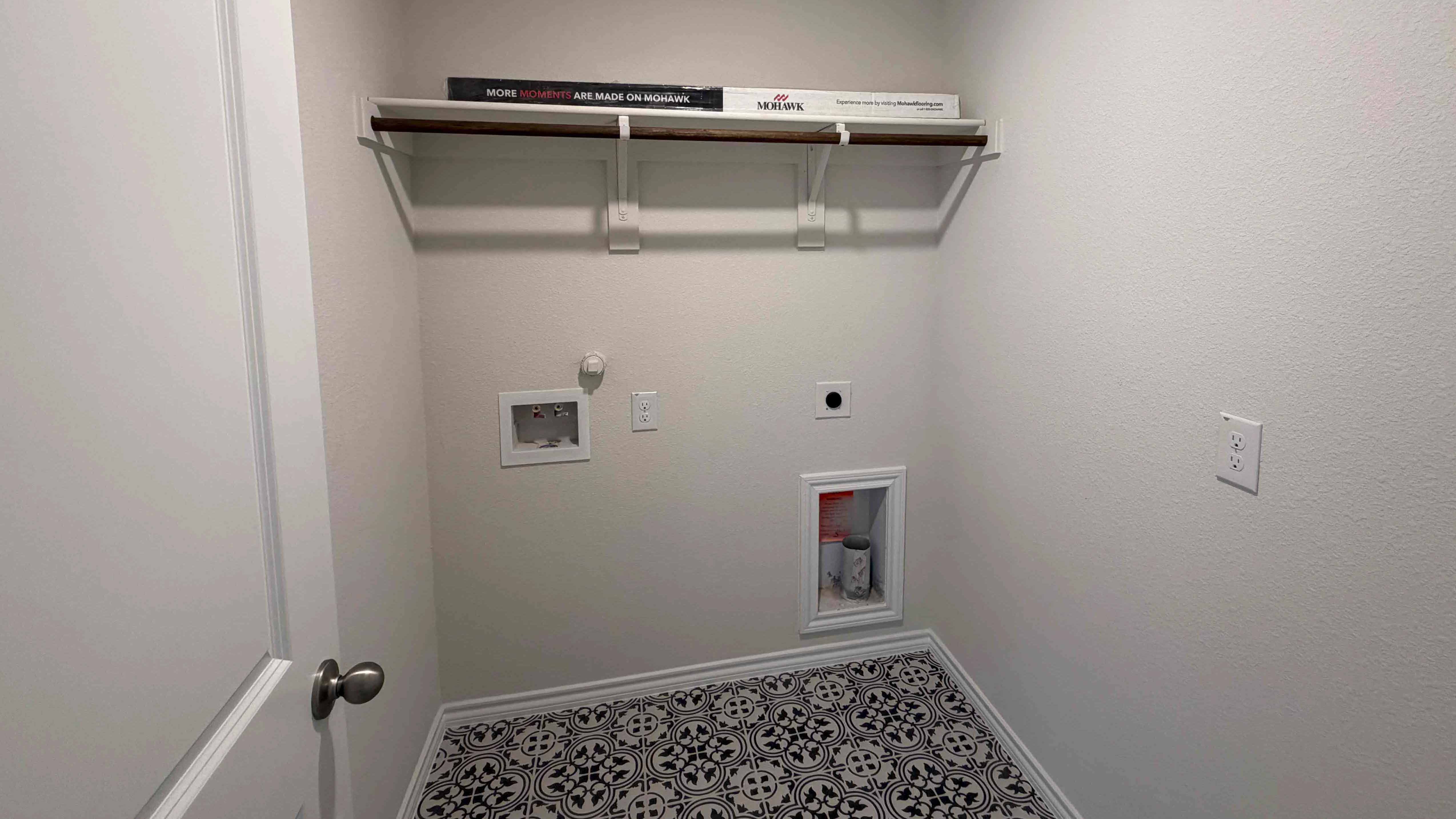 utility area for washer and dryer with tile