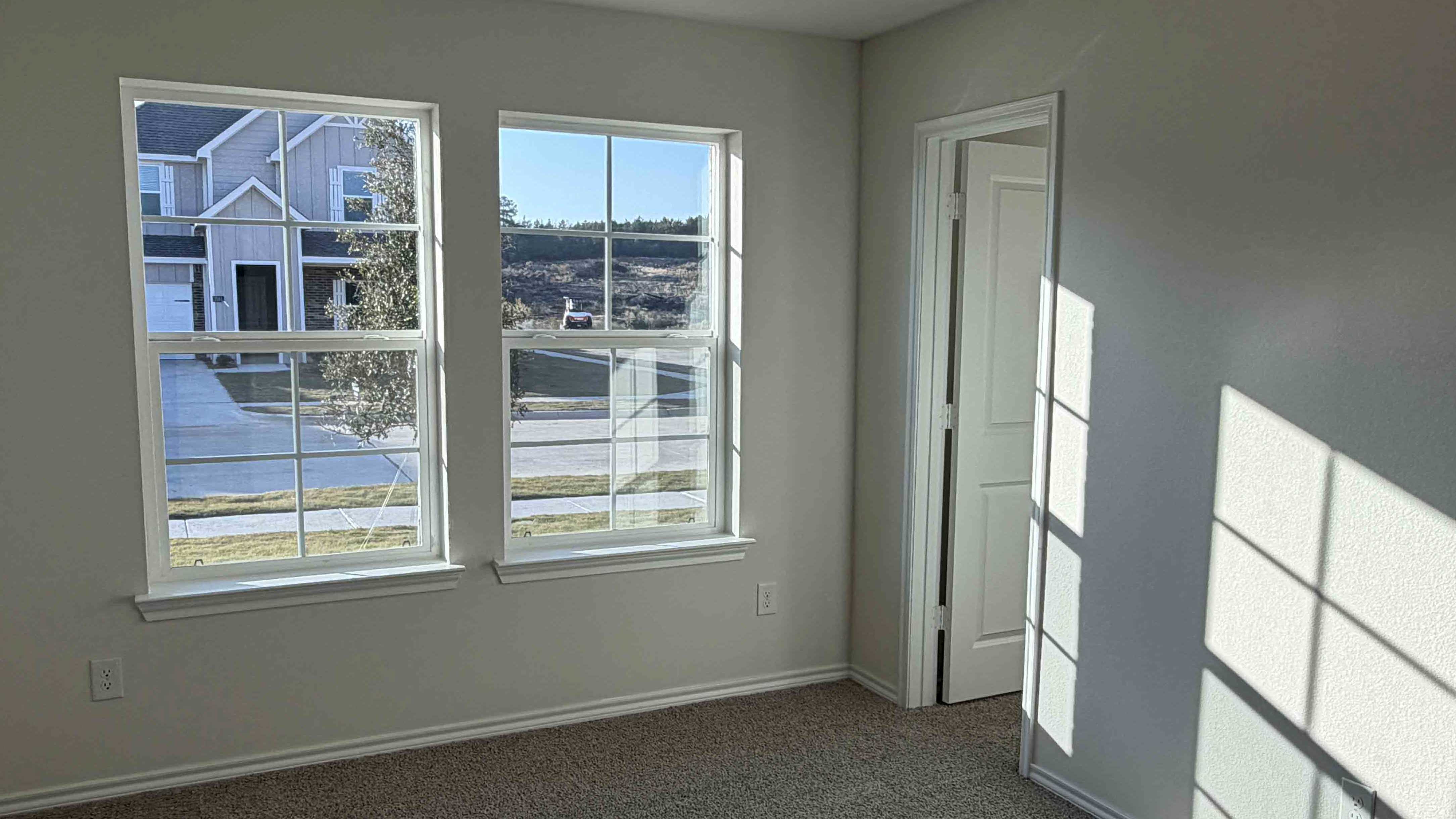 secondary bedroom with large window providing natural light