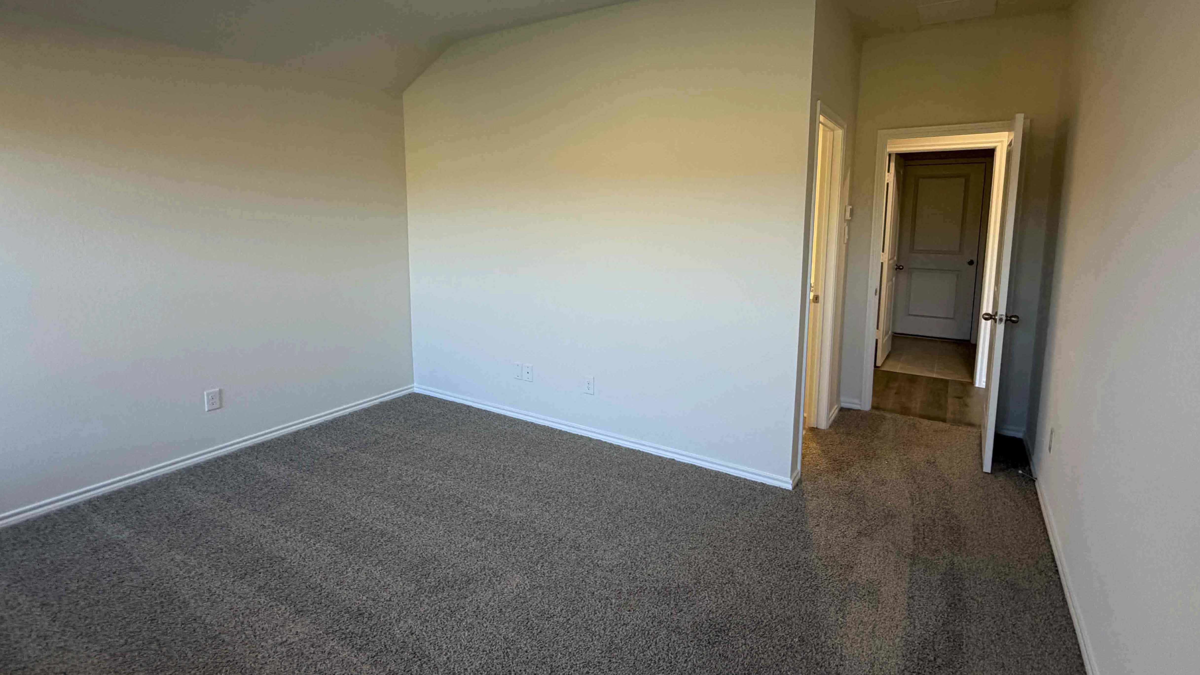 secondary bedroom with large window providing natural light