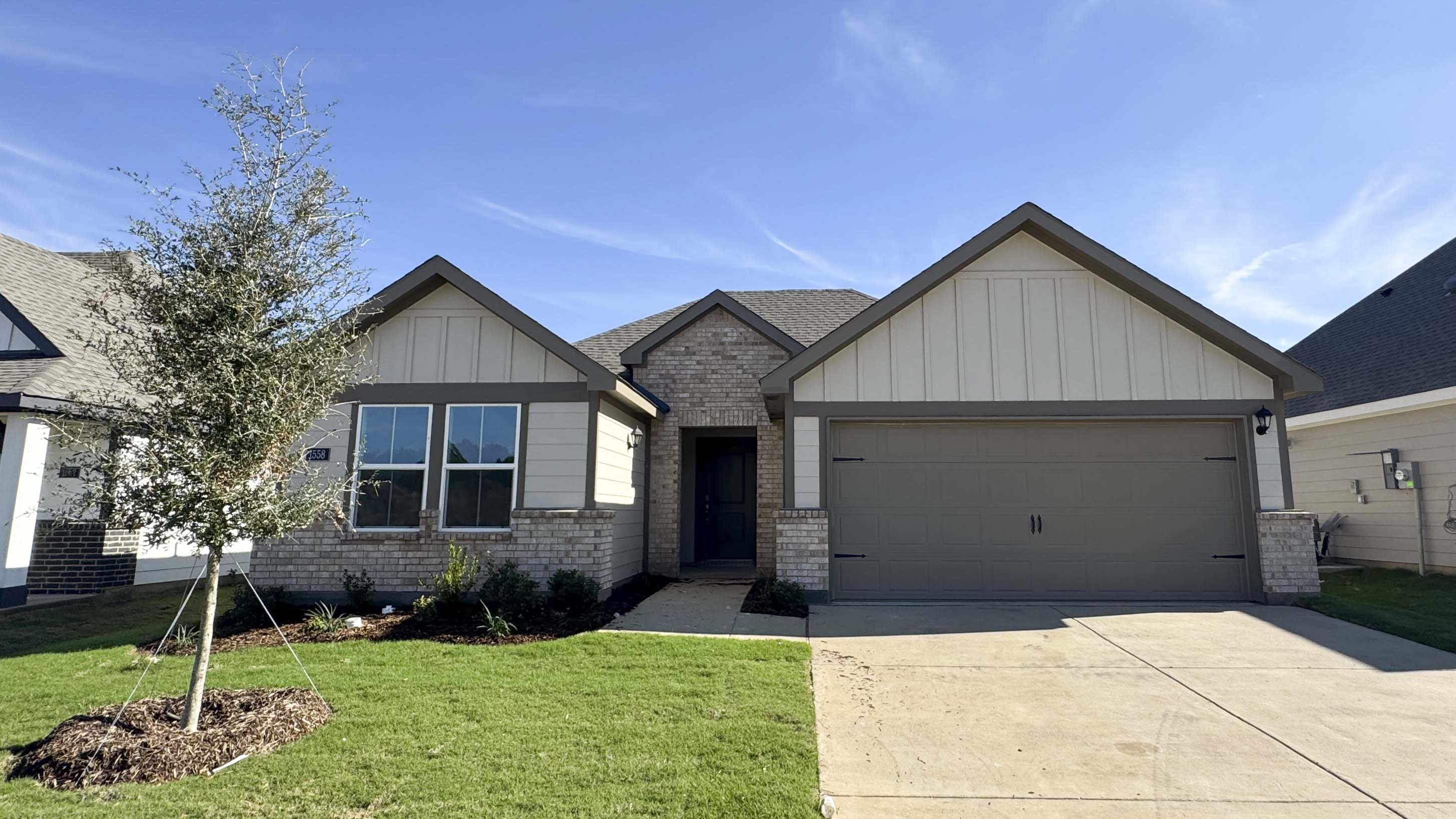 exterior of one story home with siding and large window facing the front yard