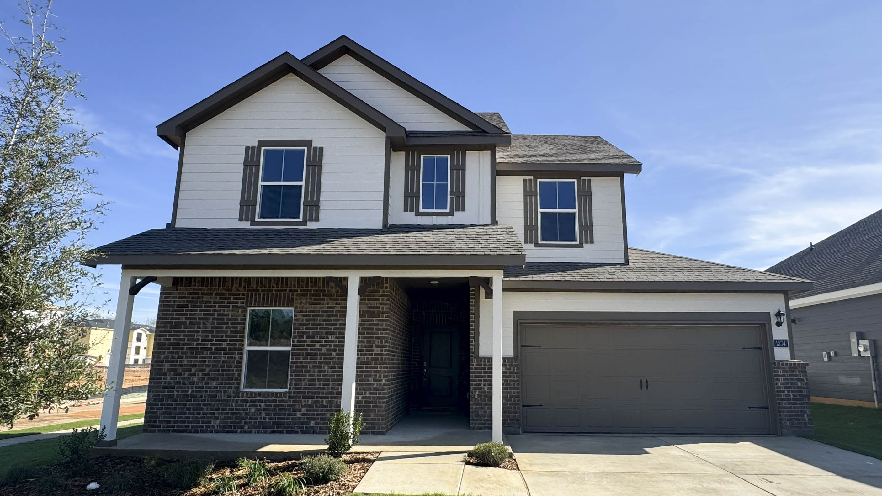 exterior of two story home with siding and front porch with middle entry to the home