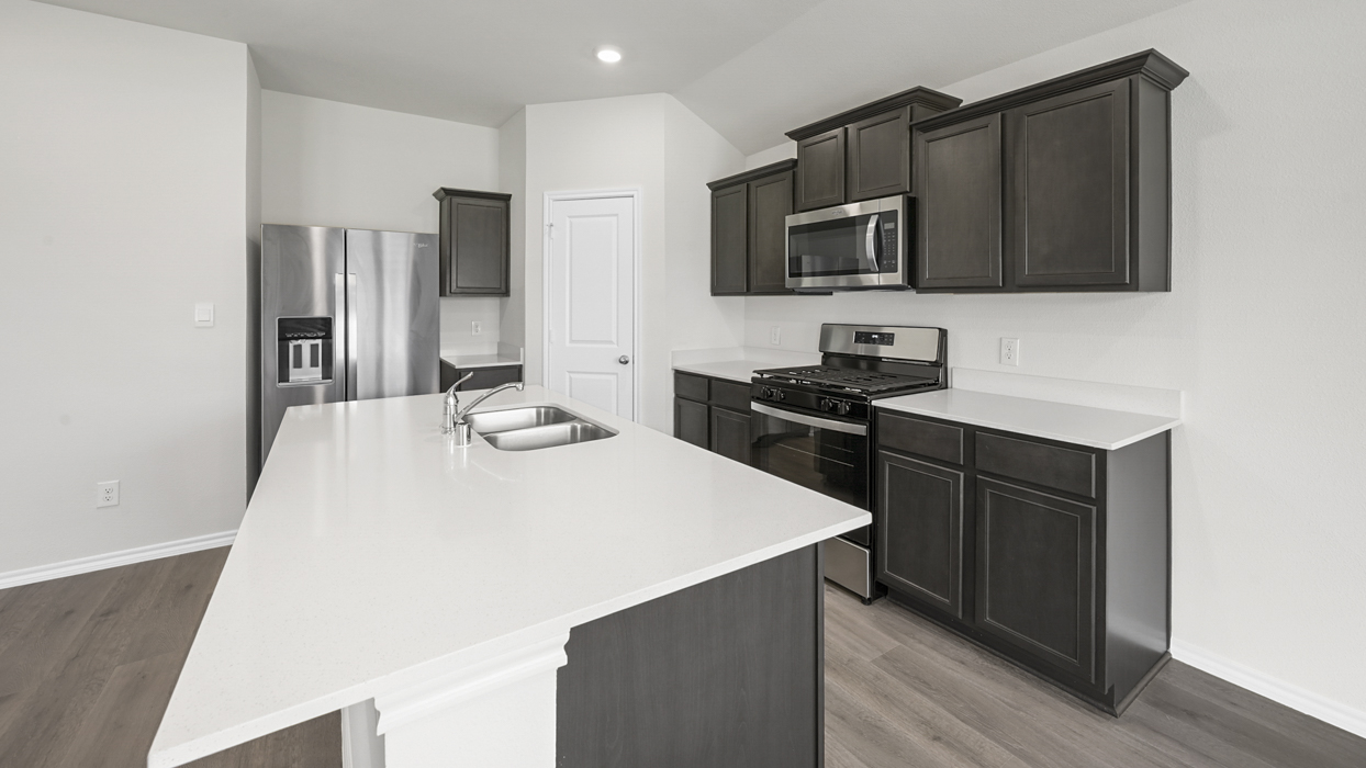 kitchen view with brown cabinets and white counter tops