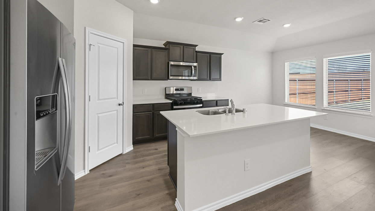 kitchen view with brown cabinets and white counter tops