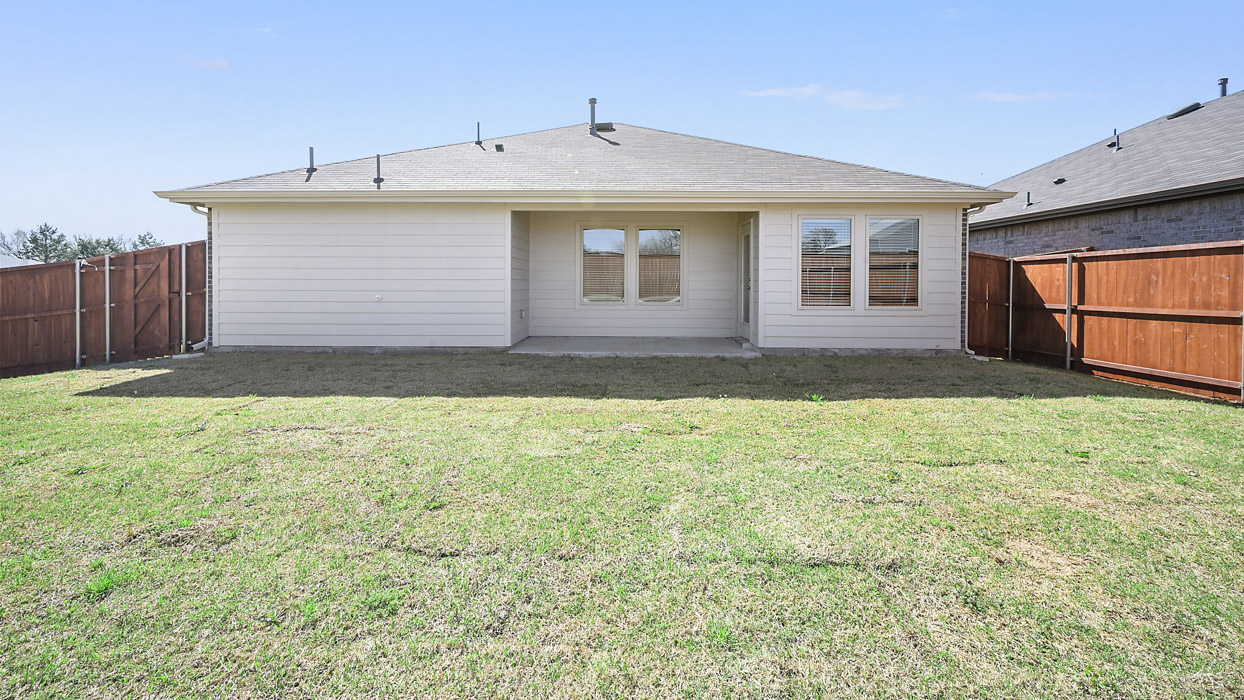 back side of one story home with siding and covered back patio