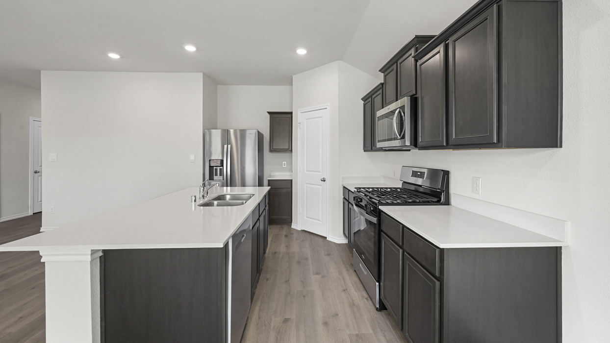 kitchen with dark brown cabinets and white countertops