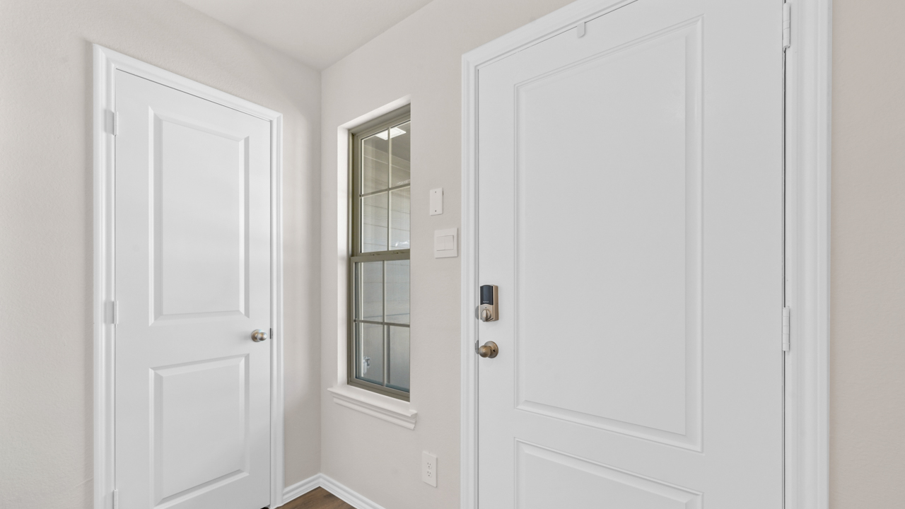 Interior entry with large white door and large window