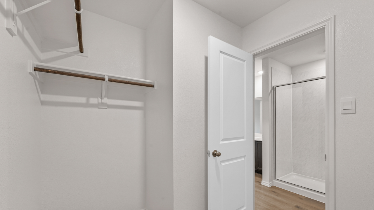 Primary bedroom closet located in the bathroom