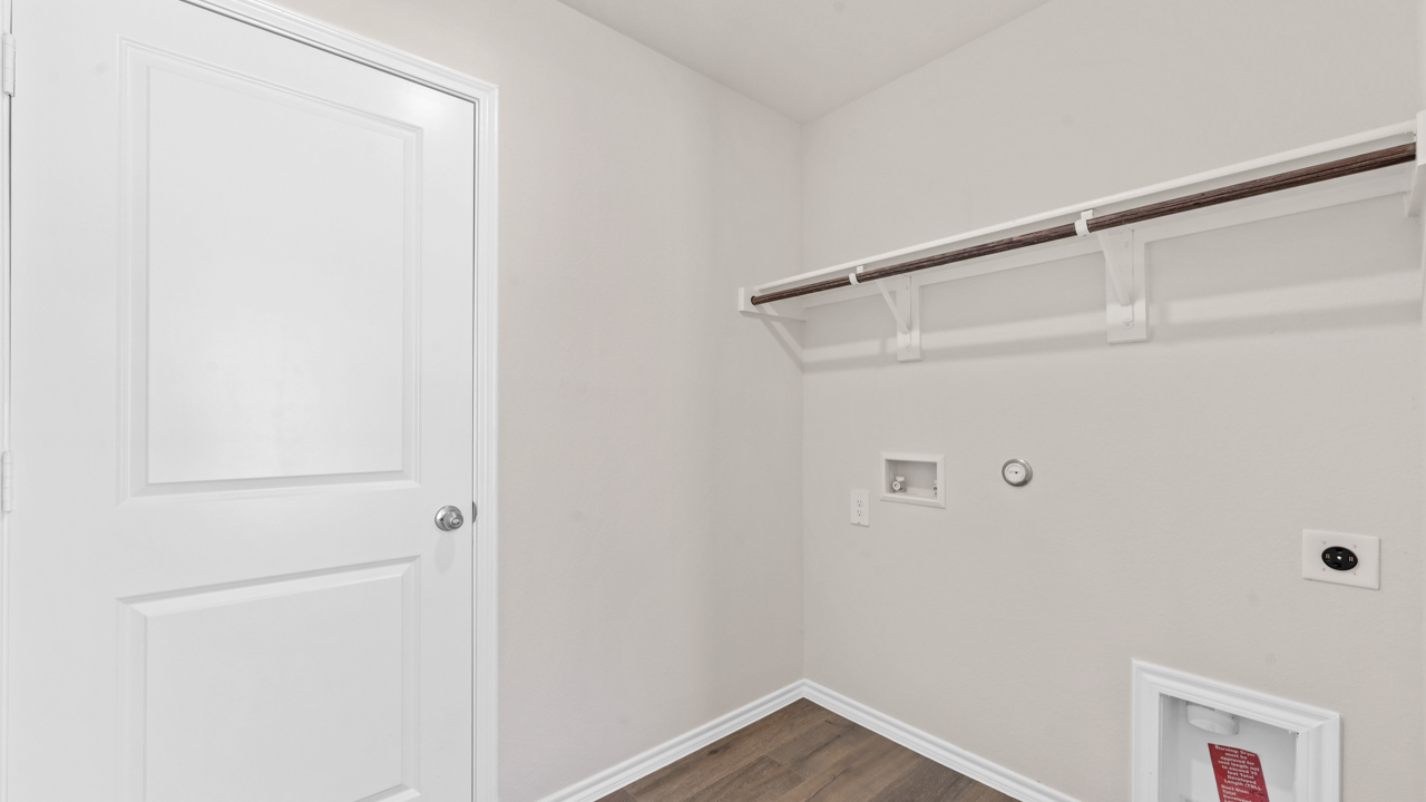 Utility area for washer and dryer with hardwood floors