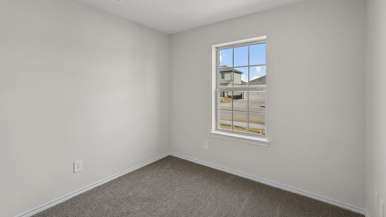an open bedroom with white walls and gray carpet