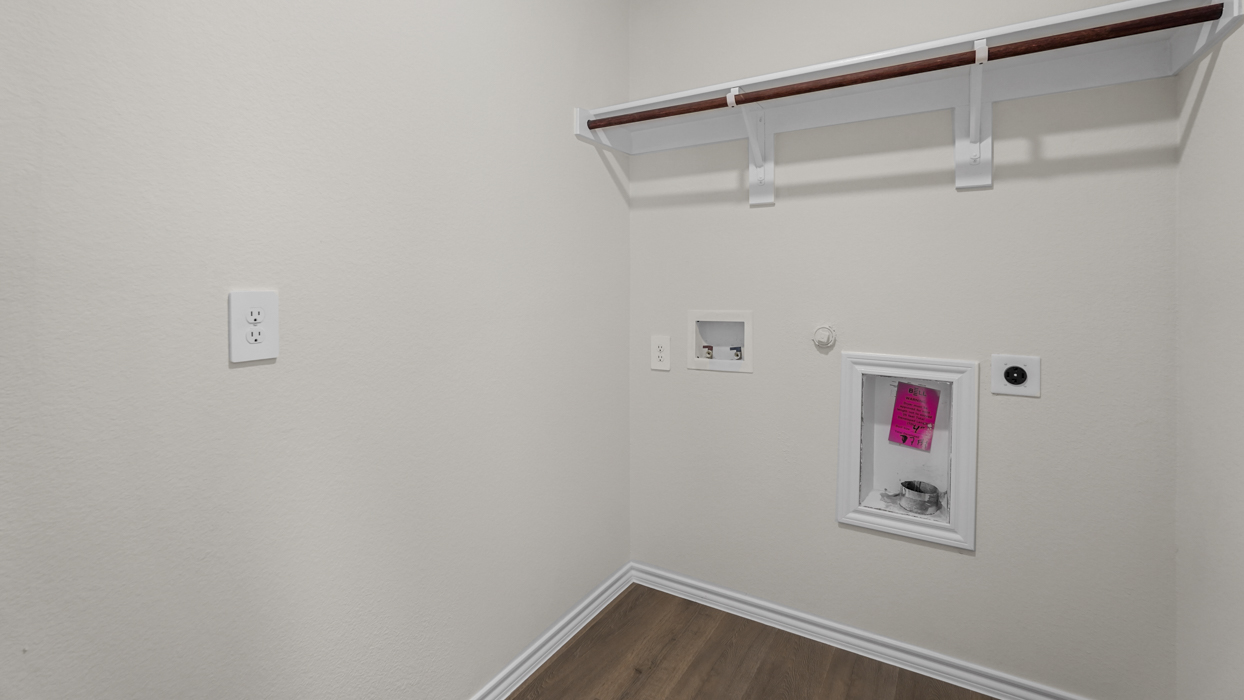 an empty utility closet with hook ups for a washer and dryer