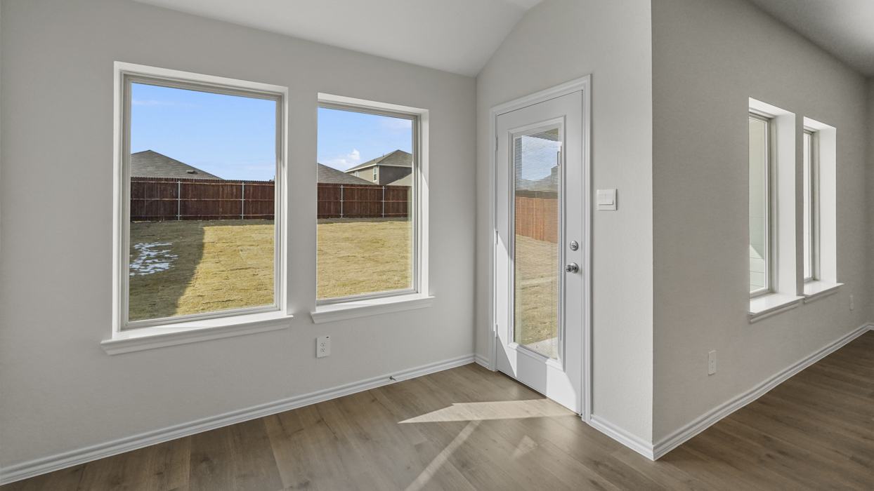 an open living area with white walls and wood floors
